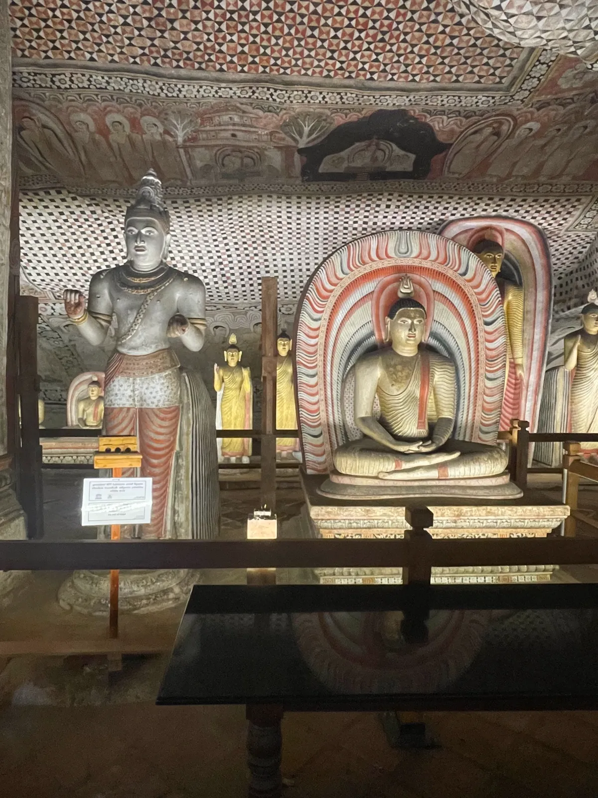 Buddha statues and colourful murals on the cave walls of the Dambulla temple
